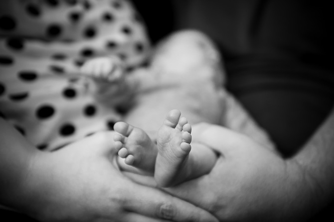 Holding the tiny feet.