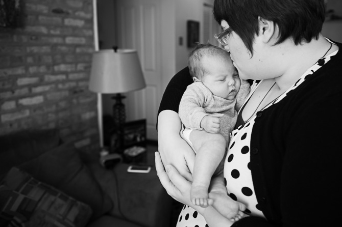 Mom kissing her newly born son.
